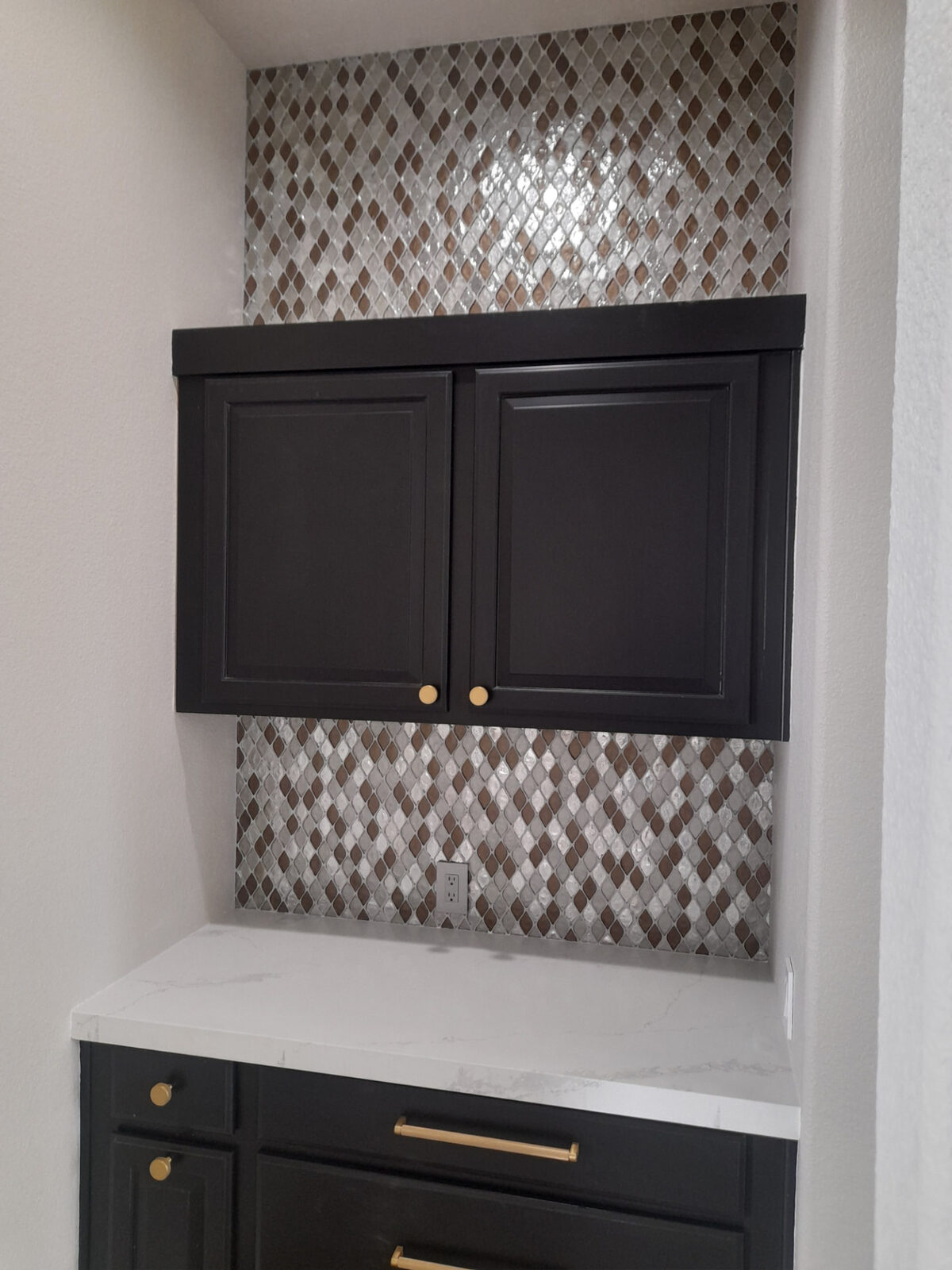 Glass mosaic diamond tile backsplash in a coffee bar niche with dark cabinets and quartz counter